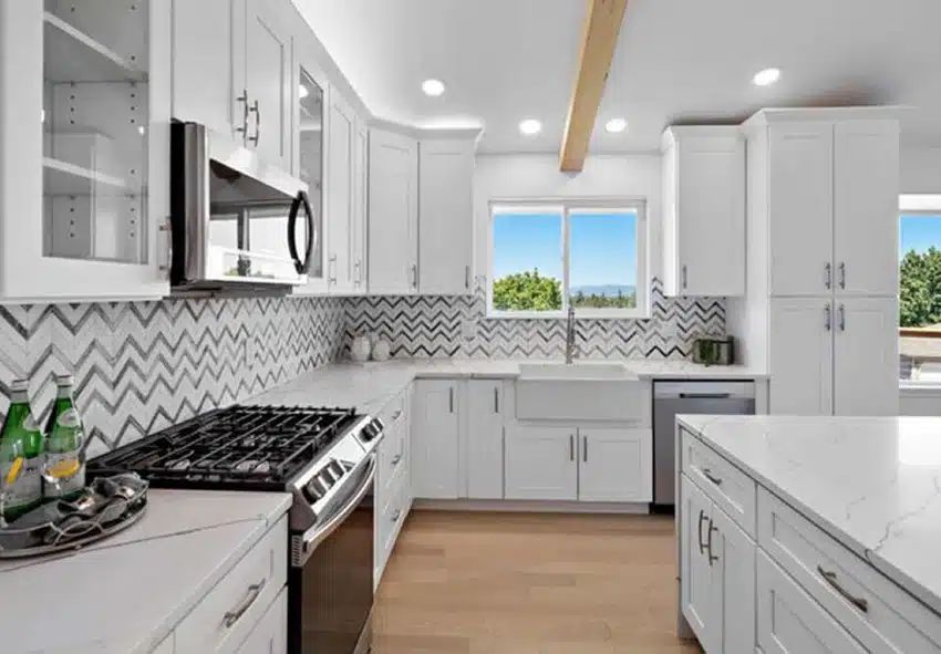 Contemporary kitchen featuring wood cabinets a wide island quartz counters and warm lighting