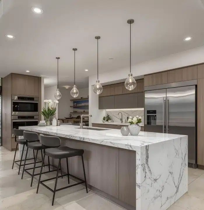 Contemporary kitchen with two tone cabinets wide island quartz countertops and layered lighting