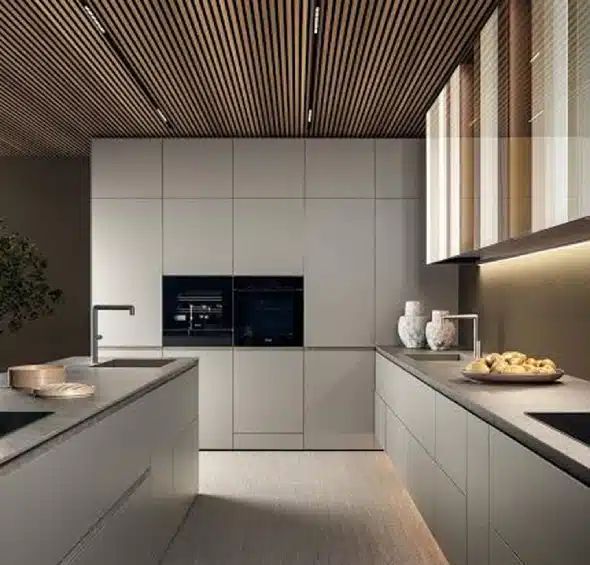 Modern kitchen with sleek cabinetry large center island stone countertops and contemporary lighting