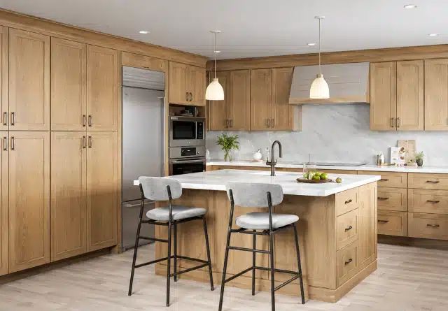 Modern kitchen with sleek cabinetry large center island stone countertops and pendant lighting