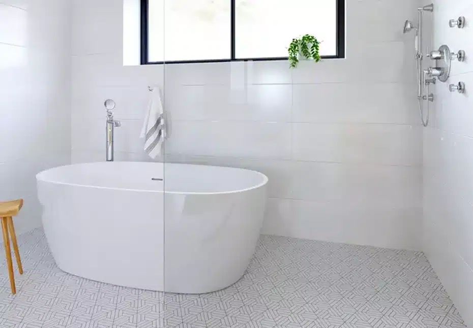 Modern wet room bathroom with frameless glass shower floating vanity large format tile and contemporary fixtures